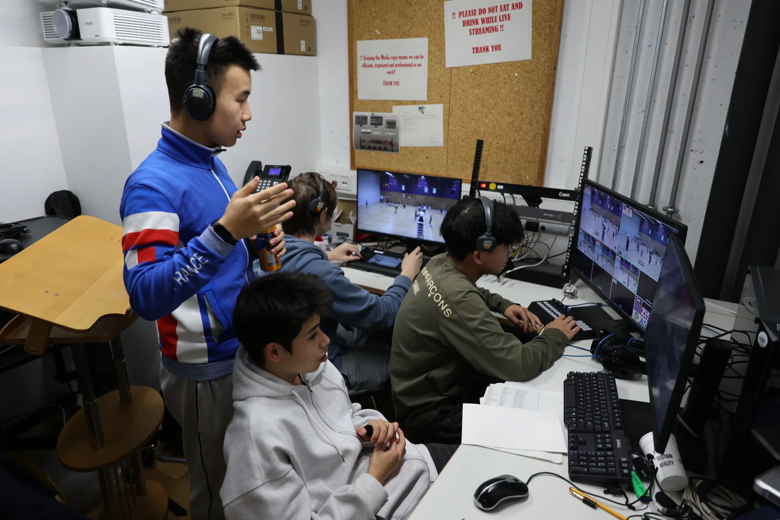 Students directing and monitoring a sports livestream from the Stroth Center control room