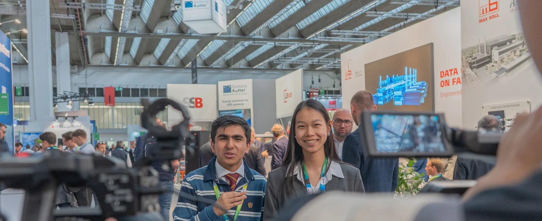 Two FIS student presenters recording an interview segment at the Frankfurt Tech Show